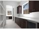 Bright pantry includes dark cabinetry, white countertops, a built-in wine cooler and ample storage at 20775 W Rattler Rd, Buckeye, AZ 85396