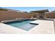 A sparkling pool and a built in outdoor fireplace make this backyard an entertainer's dream at 20775 W Rattler Rd, Buckeye, AZ 85396