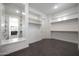 Spacious walk-in closet with open white shelves and dark tile flooring at 20775 W Rattler Rd, Buckeye, AZ 85396