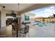 Inviting backyard with a pristine pool, dining area, and cozy fireplace for outdoor relaxation at 20977 W Mariposa St, Buckeye, AZ 85396
