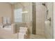 Modern bathroom with a separate tub and shower, complemented by stylish tile work at 20977 W Mariposa St, Buckeye, AZ 85396