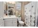 Bright bathroom featuring a single sink vanity, decorative accents, and shower with curtain at 20977 W Mariposa St, Buckeye, AZ 85396