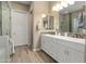 Bright bathroom featuring double sinks, a walk-in shower, and tile flooring at 20977 W Mariposa St, Buckeye, AZ 85396