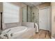 Relaxing bathroom with a soaking tub, walk-in shower, and neutral tile finishes at 20977 W Mariposa St, Buckeye, AZ 85396