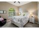 Comfortable bedroom with a large window and a white bed with colorful floral bedding at 20977 W Mariposa St, Buckeye, AZ 85396