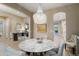 Stylish dining area showcases a chandelier and a marble-topped table with seating at 20977 W Mariposa St, Buckeye, AZ 85396