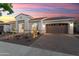 Charming single-story home featuring a well-manicured front yard with desert landscaping and a spacious driveway at 20977 W Mariposa St, Buckeye, AZ 85396