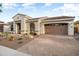 Beautiful single-story home with a well-maintained front yard, desert landscaping, and a spacious two-car garage at 20977 W Mariposa St, Buckeye, AZ 85396