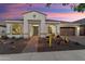 Single-story home with desert landscaping, a tile roof, and welcoming entrance at twilight at 20977 W Mariposa St, Buckeye, AZ 85396