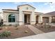 Charming single-story home featuring a desert landscape, tile roof, and inviting front entrance at 20977 W Mariposa St, Buckeye, AZ 85396