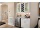 Dry bar with a wine rack, storage cabinets, stainless steel beverage fridge, and stylish countertops at 20977 W Mariposa St, Buckeye, AZ 85396