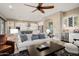 Bright and airy living room showcases a white sofa, an accent rug, and seamless connection to the modern kitchen at 20977 W Mariposa St, Buckeye, AZ 85396