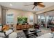 Spacious living room with ample seating, a ceiling fan, and access to the outdoor space at 20977 W Mariposa St, Buckeye, AZ 85396