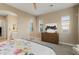Spacious bedroom with a dresser, artwork, and a glimpse into the en suite bathroom at 20977 W Mariposa St, Buckeye, AZ 85396