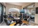 Stylish outdoor living area features a fireplace, comfortable seating, and seamless indoor-outdoor flow at 20977 W Mariposa St, Buckeye, AZ 85396