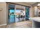 Sliding glass doors leading to a beautiful outdoor patio with a dining table and a pool at 20977 W Mariposa St, Buckeye, AZ 85396