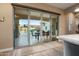 Sliding glass doors leading to a beautiful outdoor patio with a dining table and a pool at 20977 W Mariposa St, Buckeye, AZ 85396
