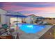 Sparkling pool area with luxurious lounge chairs and umbrellas, perfect for relaxation and outdoor enjoyment at 20977 W Mariposa St, Buckeye, AZ 85396