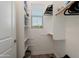 Well-organized walk-in closet with ample shelving, hanging space, and a window for natural light at 20977 W Mariposa St, Buckeye, AZ 85396