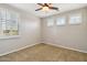 This bedroom boasts carpeted floors, a ceiling fan, and a bright window with shutters at 2270 E Honeysuckle Pl, Chandler, AZ 85249