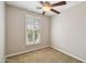 Neutral bedroom featuring window with wood shutters and a ceiling fan at 2270 E Honeysuckle Pl, Chandler, AZ 85249