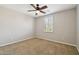 This bedroom features a ceiling fan, carpet, and shuttered window providing natural light at 2270 E Honeysuckle Pl, Chandler, AZ 85249