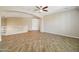Open bonus room boasts wood-look tile floors, a ceiling fan, and natural light at 2270 E Honeysuckle Pl, Chandler, AZ 85249