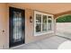 Covered entryway featuring a wrought-iron front door, decorative window, and stucco walls at 2270 E Honeysuckle Pl, Chandler, AZ 85249