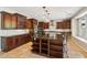 Spacious kitchen features dark wood cabinets, stainless appliances, and a large island with bar seating at 2270 E Honeysuckle Pl, Chandler, AZ 85249