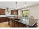 The kitchen island boasts dark granite countertops, modern pendant lights, and views to the backyard at 2270 E Honeysuckle Pl, Chandler, AZ 85249