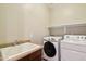 Practical laundry room featuring a sink, countertop, and modern washer and dryer at 2270 E Honeysuckle Pl, Chandler, AZ 85249