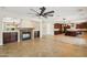 Open-concept living room with a fireplace, tile flooring, and view to the gourmet kitchen at 2270 E Honeysuckle Pl, Chandler, AZ 85249