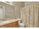 Well-maintained bathroom with granite countertop, framed mirror, and shower with curtain at 2600 E Springfield Pl # 58, Chandler, AZ 85286