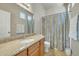 Stylish bathroom with a large mirror, granite countertop, and shower with decorative curtain at 2600 E Springfield Pl # 58, Chandler, AZ 85286