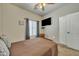 Comfortable bedroom featuring neutral colors, a ceiling fan, and a wall-mounted TV at 2600 E Springfield Pl # 58, Chandler, AZ 85286