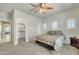 Spacious bedroom featuring a walk-in closet, carpet and natural light from arched windows at 2600 E Springfield Pl # 58, Chandler, AZ 85286