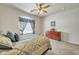 Relaxing bedroom with a ceiling fan, soft carpet, and view to a wooden dresser at 2600 E Springfield Pl # 58, Chandler, AZ 85286
