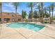 Enjoy a refreshing swim in the community pool surrounded by palm trees and fencing for a safe and relaxing experience at 2600 E Springfield Pl # 58, Chandler, AZ 85286