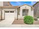 Charming home featuring a one-car garage, arched window, and manicured landscaping at 2600 E Springfield Pl # 58, Chandler, AZ 85286