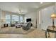 Bright living room featuring large windows, a ceiling fan, and neutral carpet at 2600 E Springfield Pl # 58, Chandler, AZ 85286