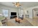 Relaxing living room featuring neutral paint, dark furniture, and a ceiling fan at 2600 E Springfield Pl # 58, Chandler, AZ 85286