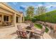 Large backyard patio with desert landscaping, built in fire pit, and outdoor furniture at 26473 W Runion Ln, Buckeye, AZ 85396