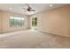 Spacious bedroom with carpet, neutral walls, and a sliding glass door to the outdoors at 26473 W Runion Ln, Buckeye, AZ 85396