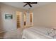 This bedroom features carpet, neutral walls, and direct access to a walk-in closet and ensuite bathroom at 26473 W Runion Ln, Buckeye, AZ 85396