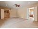 Spacious bedroom with neutral walls, carpet, ceiling fan, and direct access to two ensuite bathrooms at 26473 W Runion Ln, Buckeye, AZ 85396