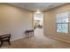 Spacious bonus room with neutral carpet and view of the dining room at 26473 W Runion Ln, Buckeye, AZ 85396