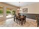 Dining room with modern chandelier and sliding glass doors to the backyard at 26473 W Runion Ln, Buckeye, AZ 85396