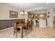 Dining room with tile floors, wooden table, and convenient kitchen access at 26473 W Runion Ln, Buckeye, AZ 85396