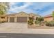Charming single-story home with a well-maintained front yard and a two-car garage at 26473 W Runion Ln, Buckeye, AZ 85396