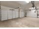 Spacious three car garage features built-in cabinets, overhead storage, and epoxy flooring at 26473 W Runion Ln, Buckeye, AZ 85396